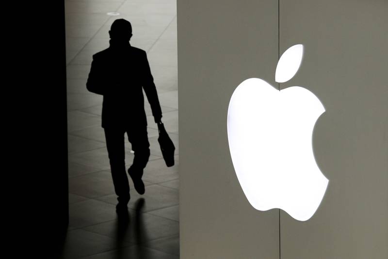 FILE – In this Jan. 3, 2019, file photo, a man leaves an Apple store in Beijing. Two years ago, Apple threatened to pull Facebook and Instagram from its app store over concerns about the platform being used as a tool to trade and sell maids in the Mideast. (AP Photo/Andy Wong, File)
