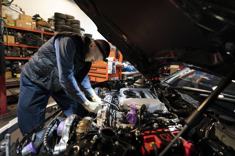 File - Mechanic David Stoliaruk works on the engine of a car at IC Auto in Philadelphia, May 2, 2023. On Friday, the U.S. government issues its November jobs report. (AP Photo/Matt Rourke, File)