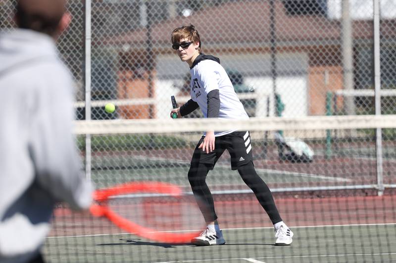 Joliet Township’s Aaron Strong looks to return a shot against Joliet Catholic’s Thomas Dvorak on Saturday, April 6, 2024 in Joliet.
