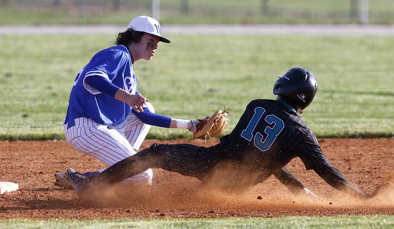 Woodstock North’s Ryan Pulaski slides into second base as Woodstock’s Bowen Lopez fields the throw as Pulaski steals the balls during a Kishwaukee River Conference baseball game Tuesday, April 18, 2023, at Emricson Park.