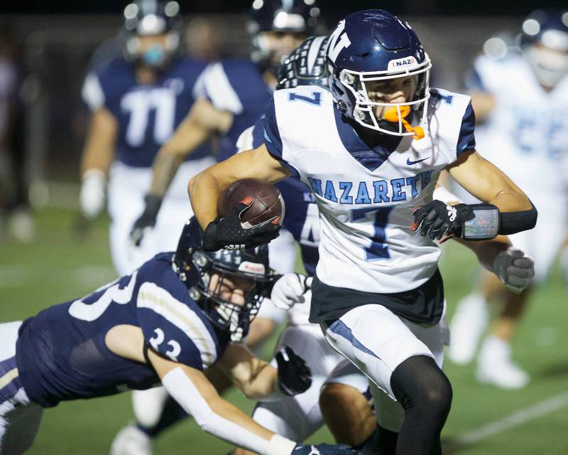 Nazareth's Jake Cestone avoids the tackle by IC Catholic's Joey Gliatta on Friday, Sept.15, 2023 in Elmhurst.