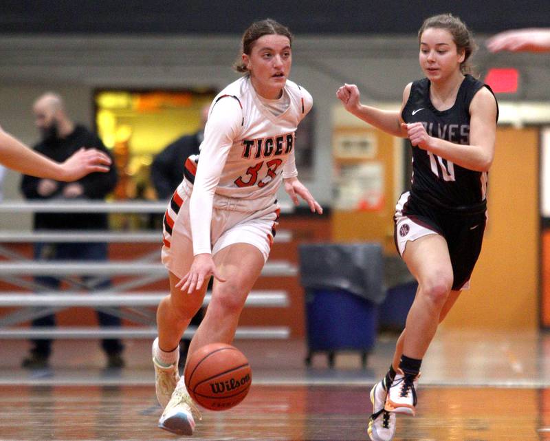 Crystal Lake Central’s Kathryn Hamill, left, moves the ball as  Prairie Ridge’s Alison Storz pursues the play in varsity girls basketball at Crystal Lake Central Tuesday.