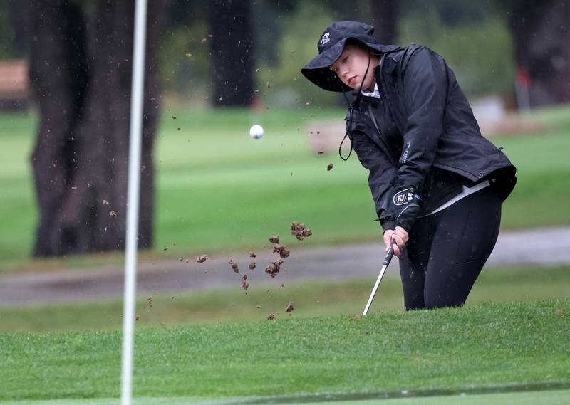 Kaneland’s Brighton Davoust hits the ball out of the bunker on the second hole Tuesday, Sept. 24, 2024, during the Interstate 8 girls golf tournament at the Sycamore Golf Club.