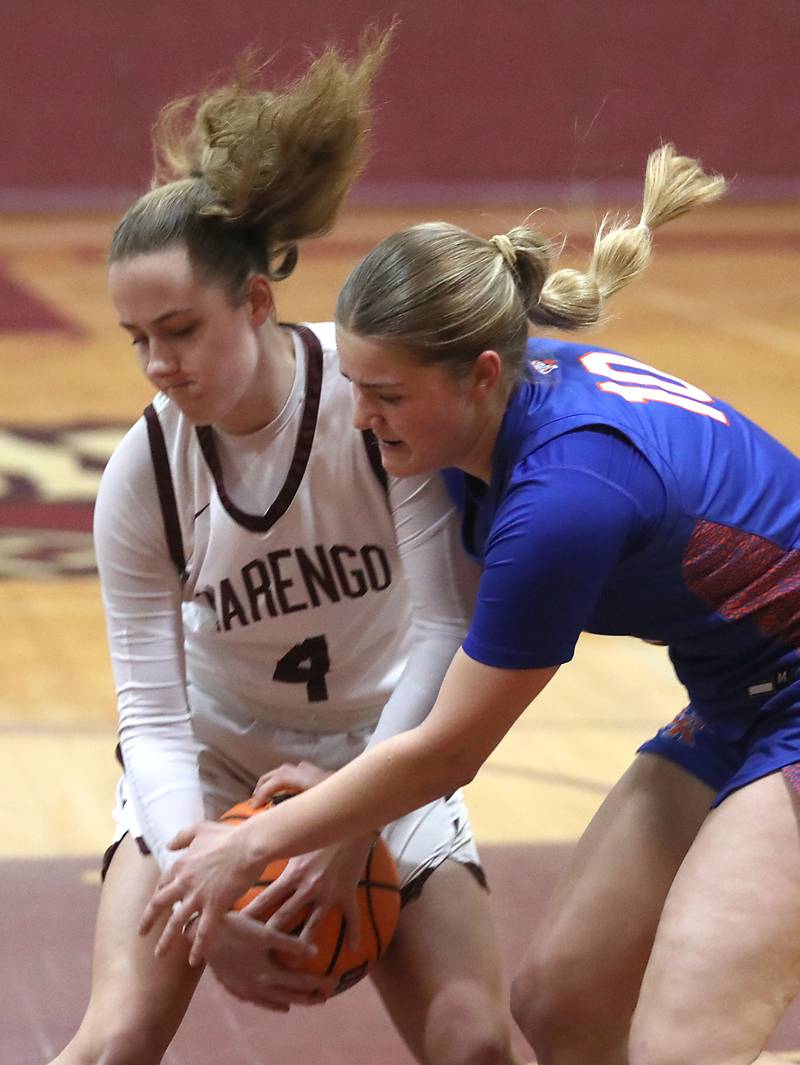 Marengo's Katie Hanson and Genoa-Kingston's Arielle Rich battler for the ball during an IHSA Class 2A Marengo Regional semifinal girls basketball game on Monday, Feb. 16, 2026, at Marengo High School.