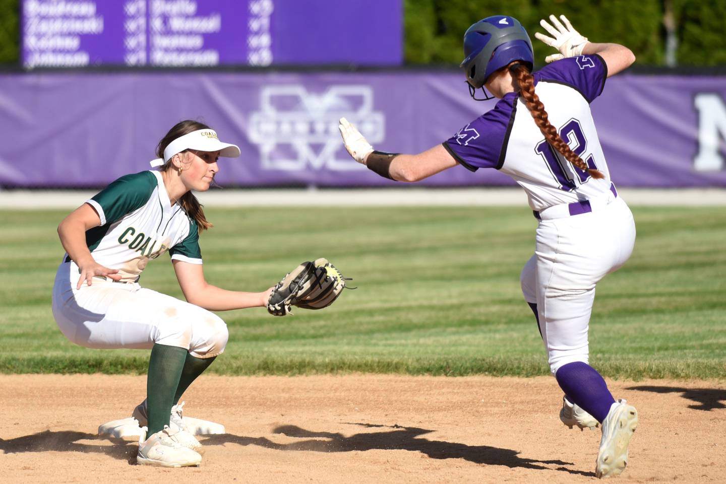 Coal City's Rese Symons, left, reaches to apply a tag on Manteno's Savanna Watkins during the Class 2A Manteno Regional semifinals Wednesday, May 20, 2026.