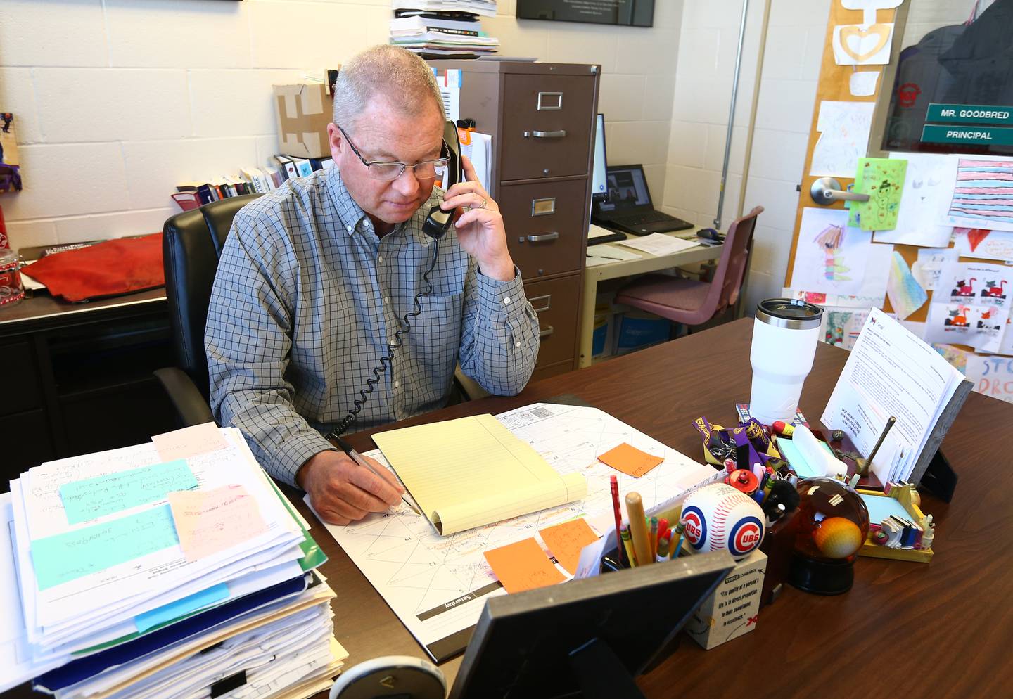 Randy Goodbred principal at Sheridan Grade School, makes a phone call at his desk on Tuesday May 15, 2022 in Sheridan.