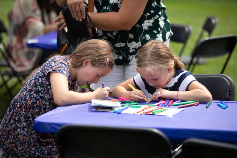Adeline (9), left, and Charlotte Reed (6) color a craft during the Voyage en France Fest at Cantigny in Wheaton on Sunday, July 16, 2023.