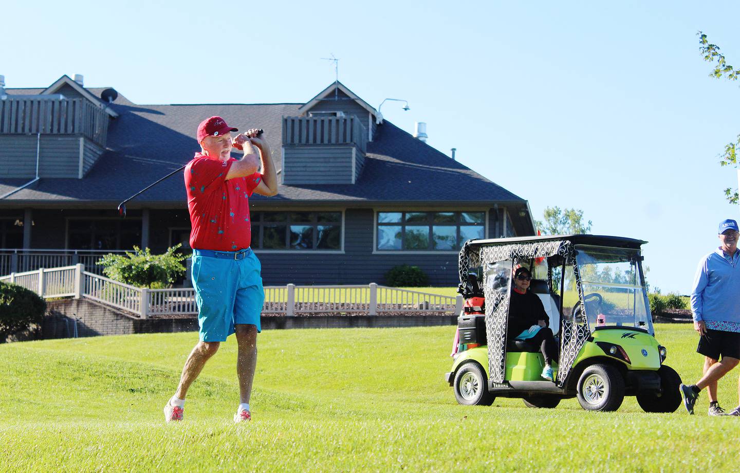 Ron Hennings tees off from No. 10 at the Lake Carroll Golf Course during the Mr. and Mrs. Club Championship on Aug. 24, as his wife Anna looks on from their golf cart.