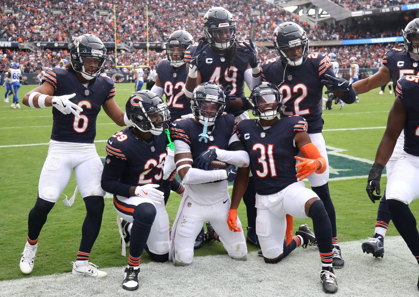 The Chicago Bears defense celebrates after Bears safety Jaquan Brisker (center) intercepted Los Angeles Rams quarterback Matthew Stafford to seal the game Sunday, Sept. 29, 2024, at Soldier Field in Chicago.