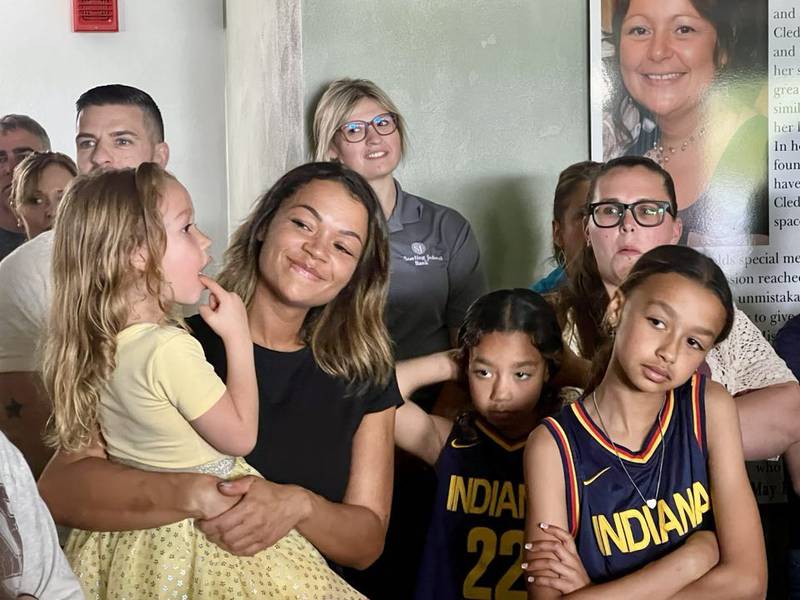 Sauk Valley Voices of Recovery's Operations Manager Lauren Metzler stands with her children at the ribboncutting of Cledy's House of Hope, a new women's sober living facility in Rock Falls.