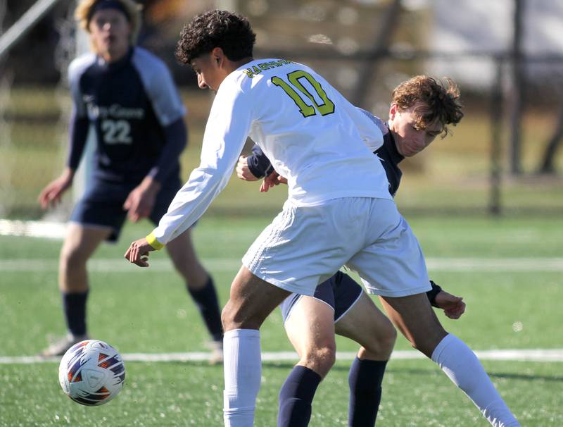 Cary-Grove’s Ethan Ehlebracht, back, gets tangled up with Harvard’s Miguel Mercado in IHSA Class 2A Regional Title Game soccer action on Saturday, Oct. 26, 2024, at  Harvard Junior High School  in Harvard.