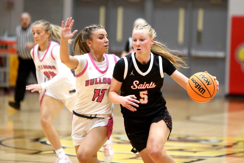 St. Charles East's Brooklyn Schilb drives toward the basket chased by Batavia's Kaidyn King during a game on Thursday, Feb. 6, 2025 in Batavia.