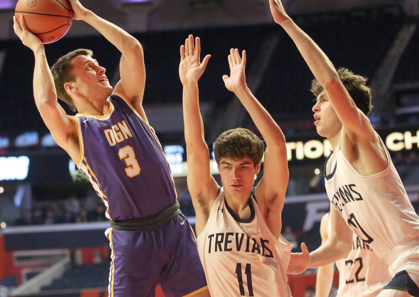 Downers Grove North's Ethan Thulin looks to shoot over New Trier's Evan Kanellos and Tyler Van Gorp in the Class 4A state third place game on Friday, March 10, 2023 at the State Farm Center in Champaign.