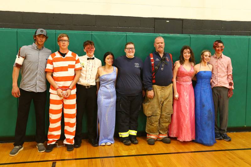 (From left) Leland high school students Porter Thrall, Andrew Salisbury, Tom Clifford, Jessica Barry, Hannah West, Leland EMT; Bob Hanson Leland Fire captain; Brynn Pennington, Malayna Kinney and Alex Todd, pose for a photo after participating in Mock Prom at Leland High School on Friday, May 6, 2022 in Leland.