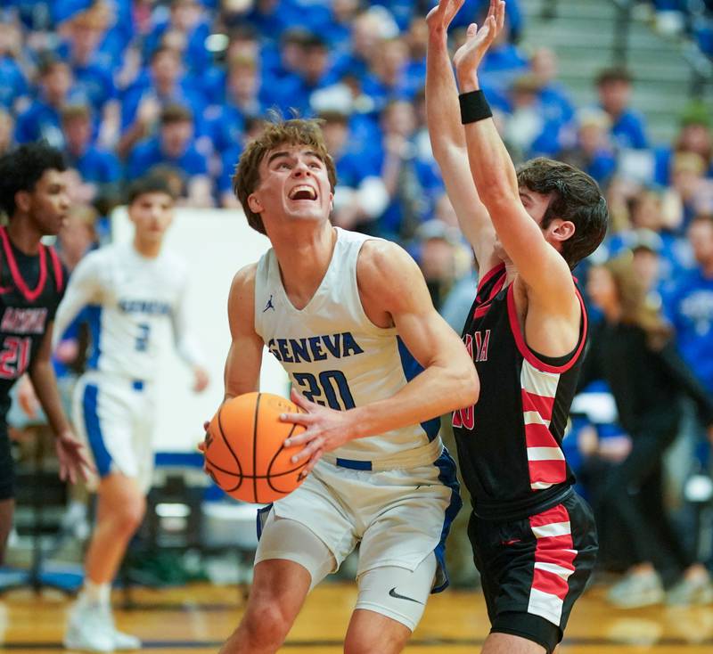 Geneva’s Jack Hatton (20) plays the ball in the post against Batavia’s Joe Reid (10) during a basketball game at Geneva High School on Friday, Feb. 7, 2025.