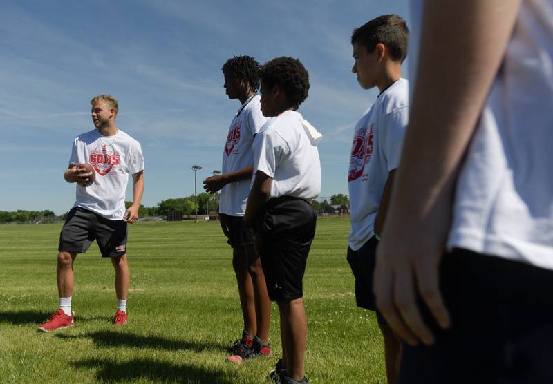 NIU’s Cole Tucker talks with students during the inaugural Legends of the 60115 Football Camp with in DeKalb on Sunday, June 26, 2022.