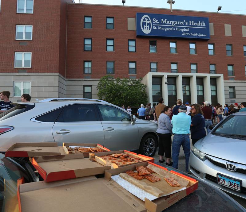 Pizzas lay on the hood of a car while St. Margaret's employees gather outside St. Margarets's Hospital for a gathering on Friday, June 16, 2023 in Spring Valley.