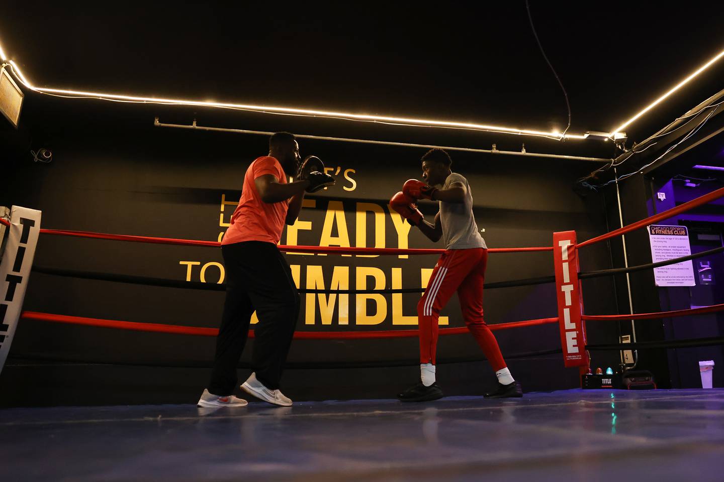 Joseph “Jojo” Awinongya (right), 15 years-old, trains with his father Joseph at Chicago Sports & Fitness on Tuesday, February 14th.