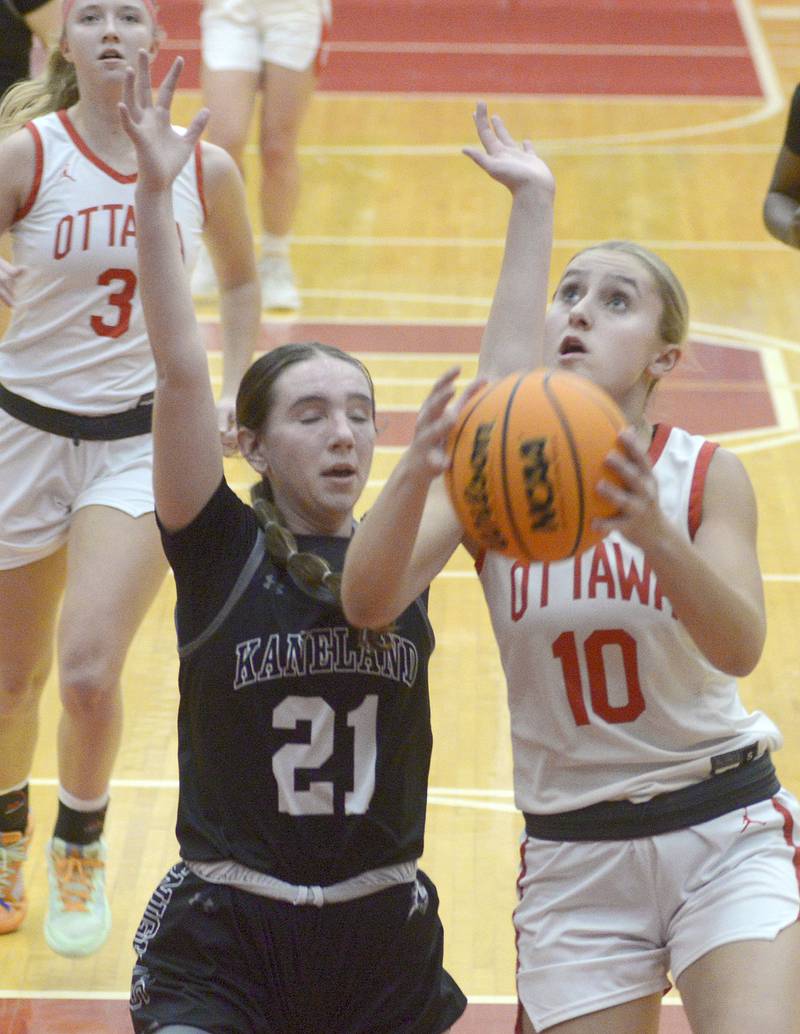 Ottawa’s Ella Schmitz eyes the basket as Kaneland’s Kyra Lilly attempts to block  in the 4th period Friday at Ottawa.