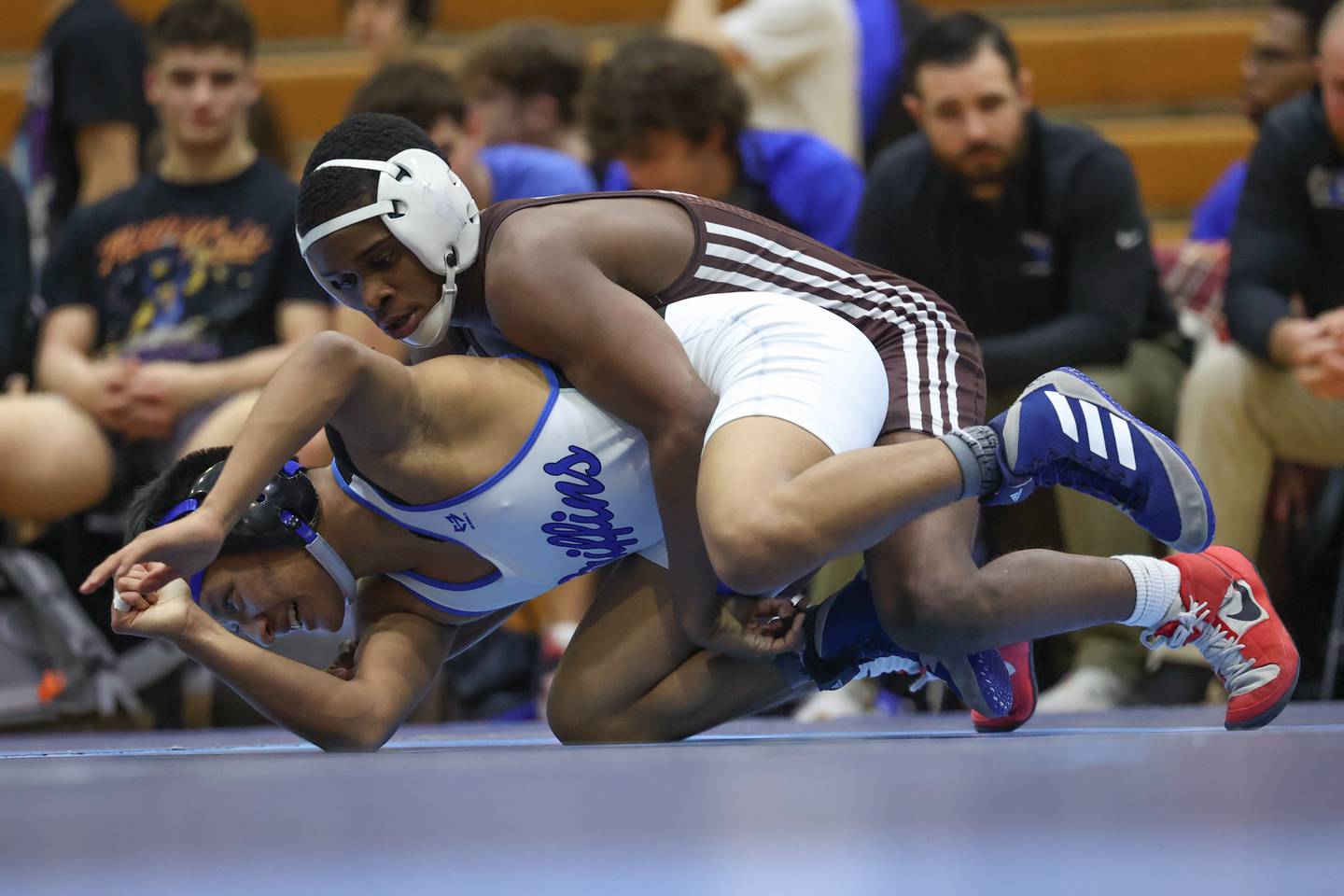 Joliet Catholic’s Jason Hampton brings down Lincoln-Way East’s Zach Miller in the Class 3A dual team sectional at Downers Grove South High School on Tuesday, Feb. 20th 2024.