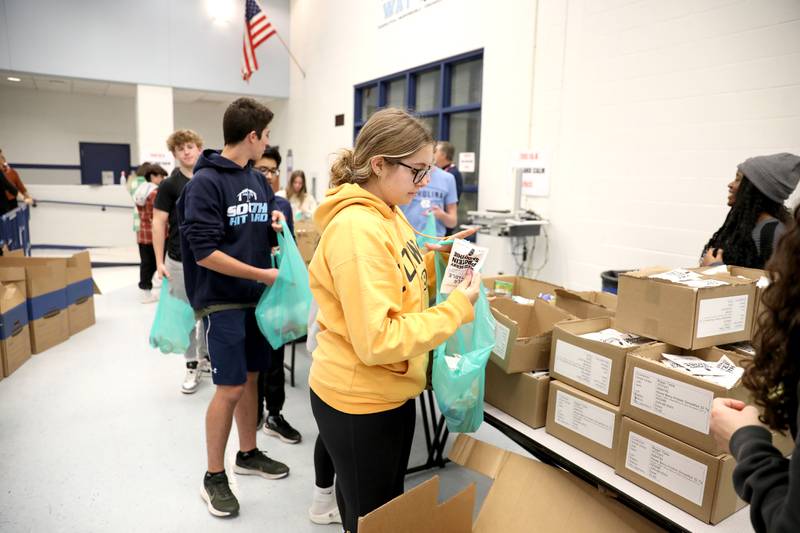 Downers Grove South High School junior Ellie Mazzeffi packs bags of food as part of the Blessings in a Backpack program on Monday, Nov. 13, 2023. The program will provide meals for 200 food insecure students in Downers Grove Grade School District 58 who won't have access to school meals during the upcoming Thanksgiving break.