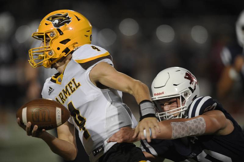 St. Viator’s Jayden Franzen catches Carmel quarterback Johnny Weber in a football game in Arlington Heights on Friday, September 16, 2022.