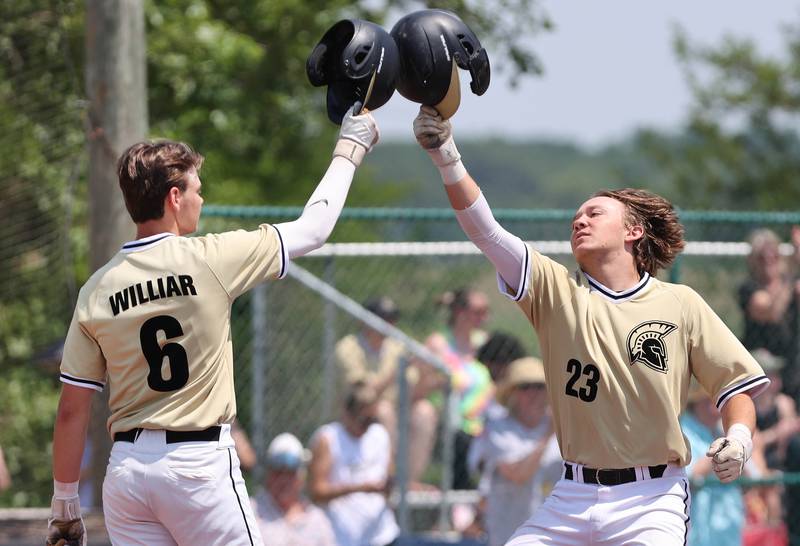 Sycamore's Kyle Hartmann is congratulated as he crosses home plate after homering by Conner Williar during their Class 3A sectional final win over Burlington Central Saturday, June 3, 2023, at Kaneland High School in Maple Park.