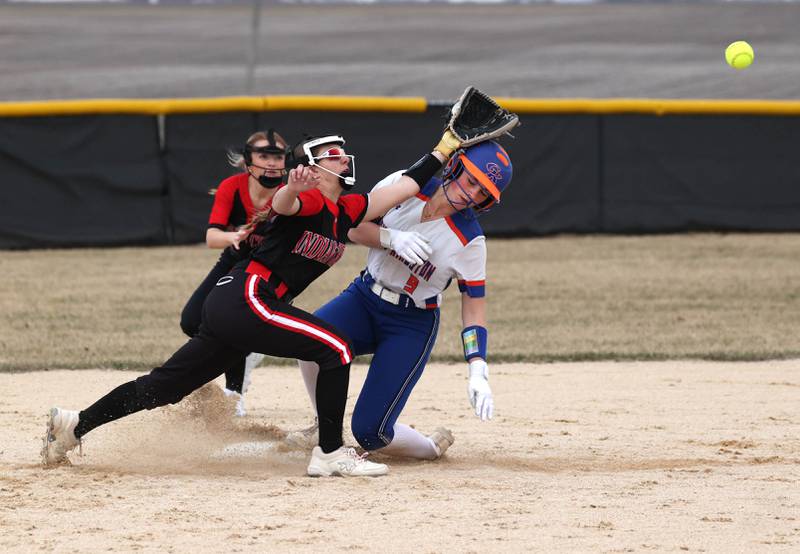 Indian Creek’s MaKenna Barshinger tries to catch an errant throw as Genoa-Kingston’s Olivia Vasak slides in with a stolen base during their game Tuesday, March 18, 2025, at Indian Creek High School in Shabbona.