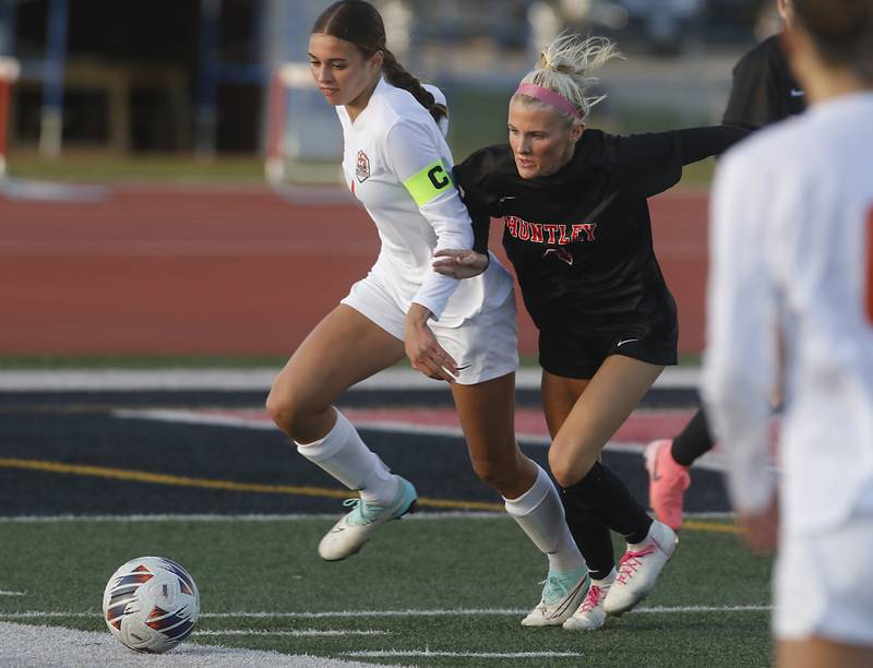 Crystal Lake Central's Hadley Ferrero battles with Huntley's Brooke Maxedon as they chase down the ball during a Fox Valley Conference  soccer match on Tuesday, April 15, 2025, at Huntley High School.