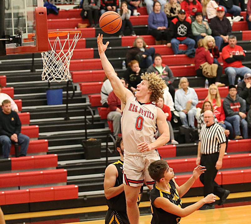 Hall's Mac Resetich (0) scores on a layup over Putnam County's Wyatt Grimshaw (25) and Jackson McDonald (23) during the Colmone Classic on Tuesday, Dec. 6, 2022 at Hall Hight School in Spring Valley.