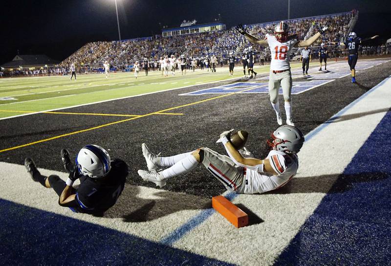 Palatine's Ryan Donnelly (18) and Palatine's Connor May (10) celebrate a touchdown over St. Charles North's Michael Hyde (7) Friday August 25, 2023 in St. Charles.