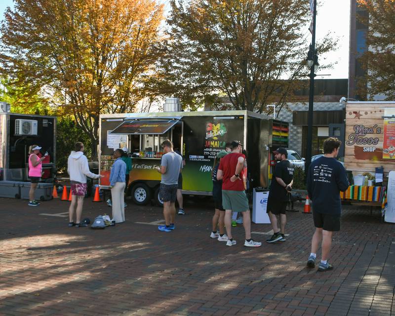 Participants enjoy food and drinks during the Taste of DeKalb after finishing the DeKalb Corn Classic 5K/10K races on Sunday, Sept. 29, 2024, downtown.