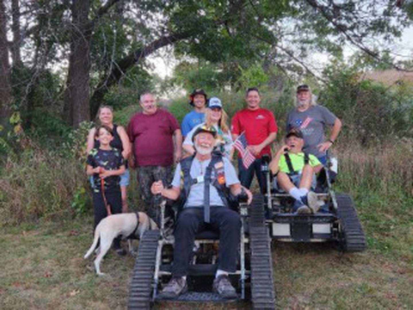 Josh Deron (in red) organizes nature hikes as part of work at Veterans Path to Hope to bring veterans and their families together to connect and heal.