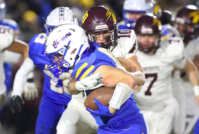Richmond-Burton’s Luke Robinson wraps up Aurora Central Catholic ballcarrier Trey Seifrid in IHSA football Class 3A second-round playoff action at Bob Stewart Field on the campus of Aurora Central Catholic High School in Aurora on Friday, November 7, 2025.