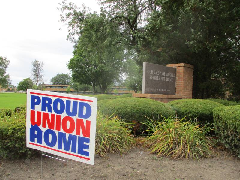 A "Proud Union Home" sign is posted in front of the monument marking Our Lady of Angels Retirement Home at the corner of Ingalls and Wyoming avenues in Joliet on Friday, Aug. 12, 2022.