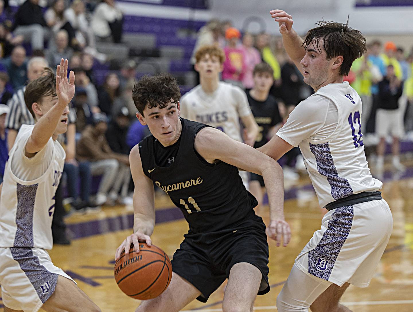 Sycamore’s Jakob Shipley handles the ball against the Dixon defense Tuesday, Jan. 23, 2024 at Dixon High School.