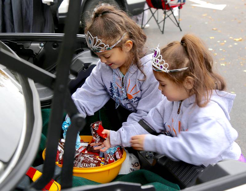 Presley and Evelyn Yarrington of Elburn pull out candy from a trunk at the 9th Annual Trunk or Treat at the Elburn Community Congregational Church on Sunday, Oct. 29, 2023 in Elburn.