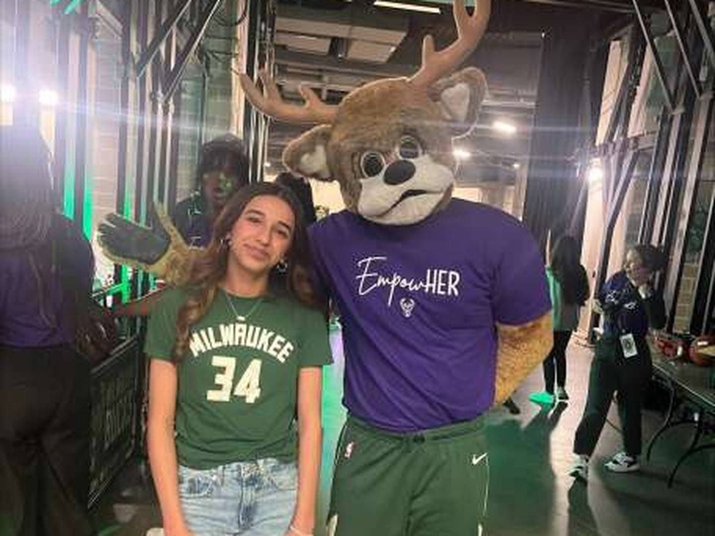 Ayanna Sidi, a 14-year-old student at Barrington Middle School's Station Campus, poses with Milwaukee Bucks mascot Bango on the night she sang the national anthem before the team's game at Fiserv Forum.