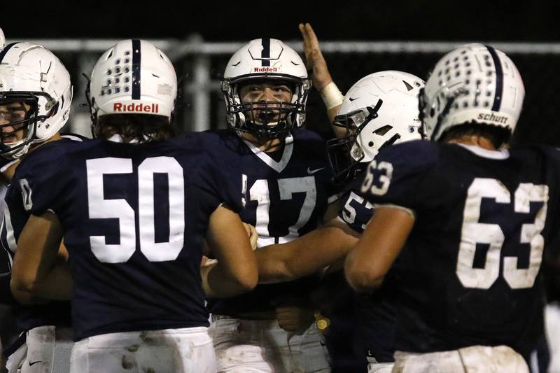 Cary-Grove quarterback Jameson Sheehan is congratulated on his touchdown run against Jacobs during their football game at Cary-Grove High School on Friday, Oct. 8, 2021 in Cary.