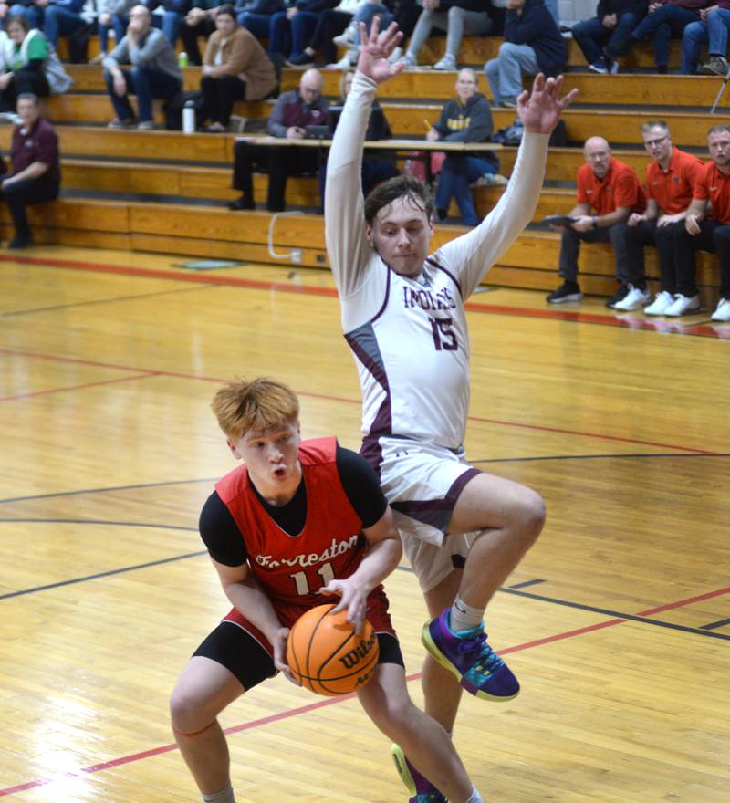 Forreston's Connor Politsch (11) gets ready to put up a shot as Dakota's Brody Keeney jumps in the air during a Tuesday, Dec. 17, 2024 game at the 63rd Annual Forreston Holiday Tournament.