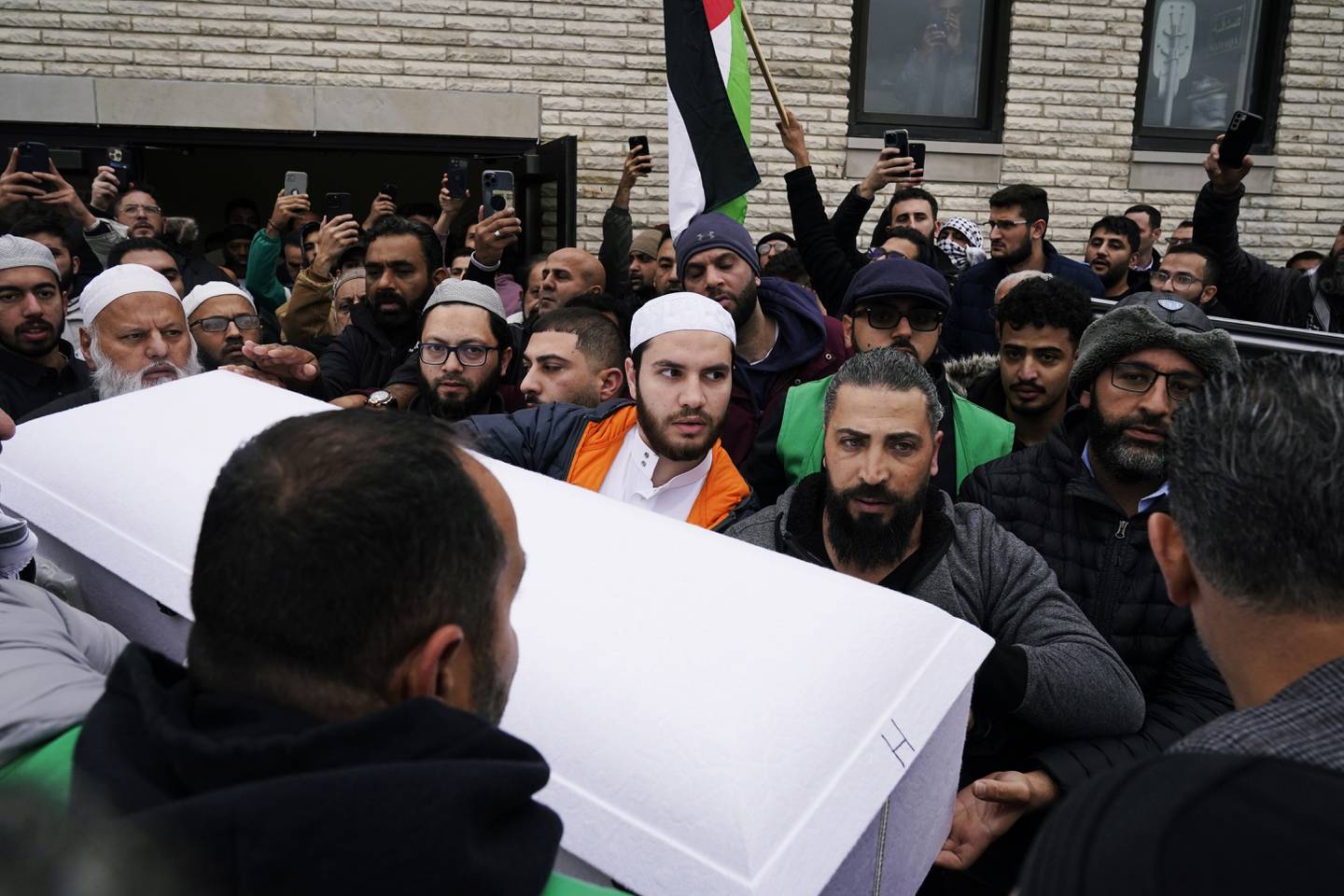 Family members of Wadea Al Fayoume bring out his casket from Mosque Foundation to the hearse in Bridgeview, Ill., Monday, Oct. 16, 2023.