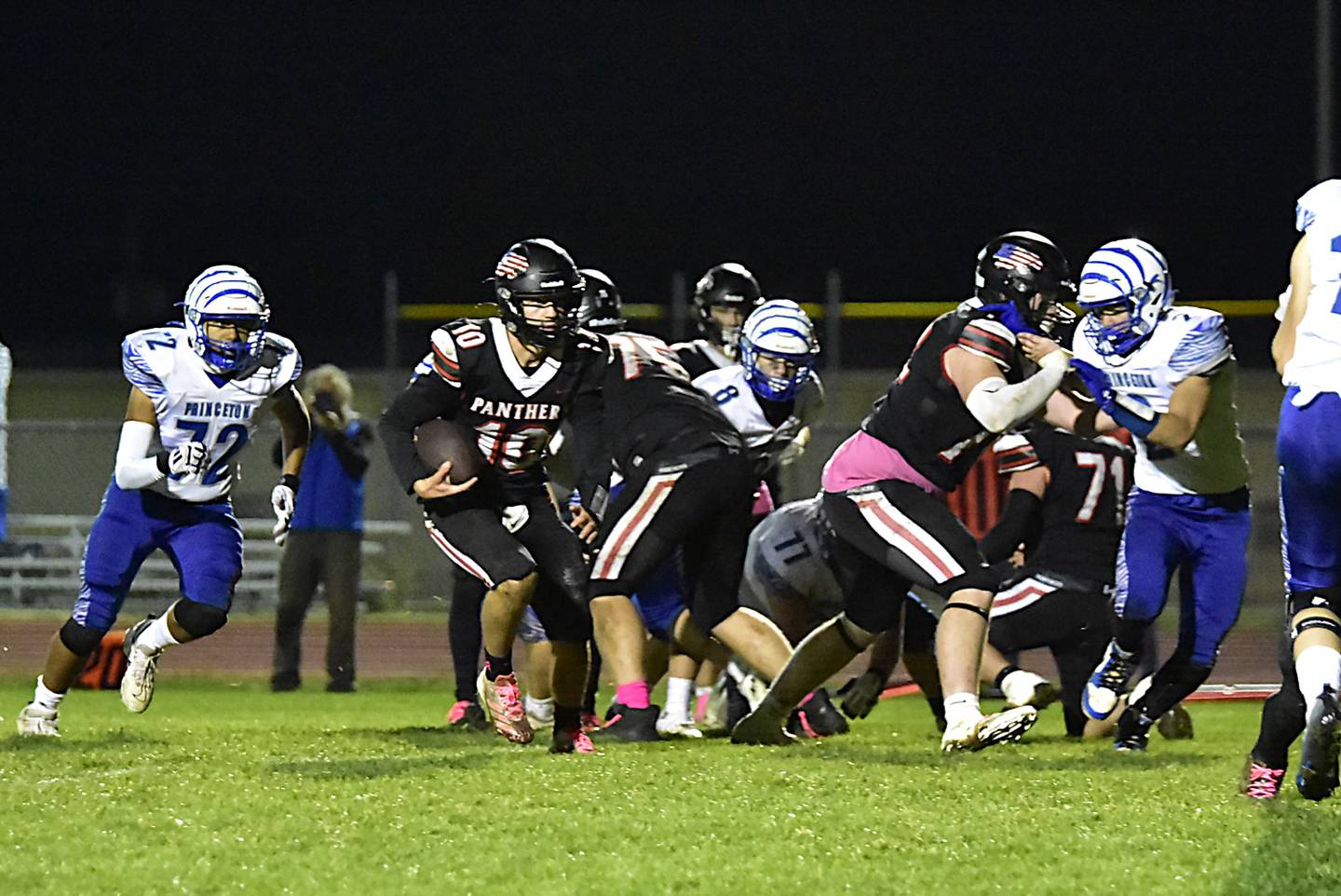 Erie-Prophetstown quarterback Keegan Winckler gets blocks from his linemen Nolan Gerlach and Caleb Reymer en route to the end zone against Princeton on Friday, Oct. 25, 2024.