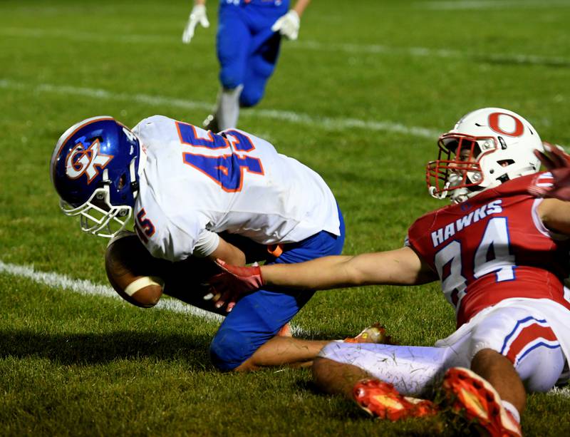 Genoa-Kingston's Maddox Lavender breaks up pass to Oregon's Anthony Bell during Friday, Sept. 30 action at Landers-Loomis Field.