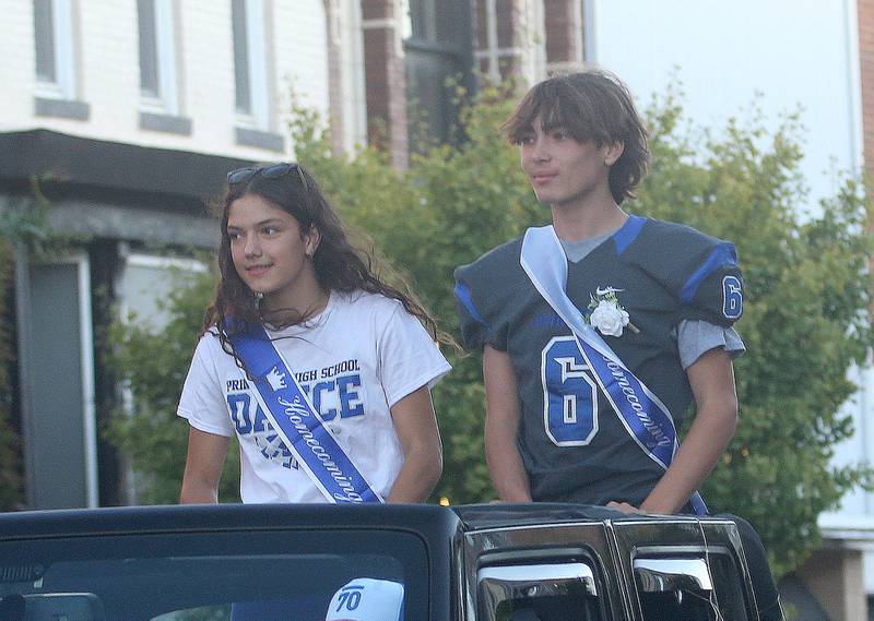 Freshman court attendants Lenora 'Hopkins and Logan Walter ride during the Princeton High School homecoming parade on Thursday, Sept. 25, 2025 along South Main Street in Princeton .