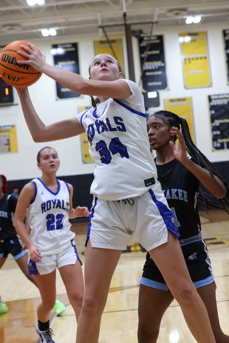 Rosary's Grace Bergeron grabs a rebound ahead of Kankakee's Shania Johnson during the Kays' 75-28 victory over Rosary at the Reed-Custer Classic on Monday, Nov. 17, 2025.