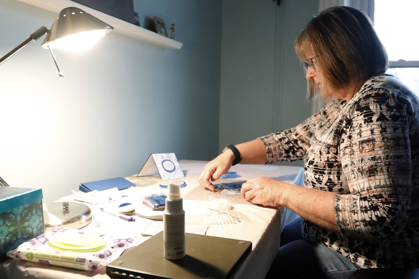 Diane Raycraft, of Crystal Lake, works on creating a handmade Christmas card for senior residents of Hearthstone on Friday, Dec. 10, 2021, in Crystal Lake.  Raycraft makes cards every month for seniors at the residence.