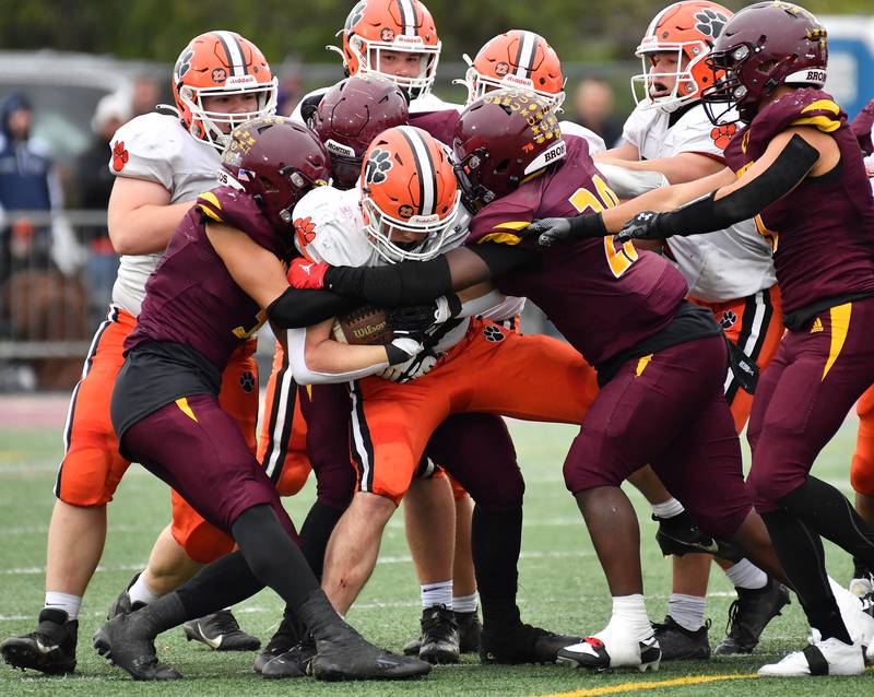 Montini defenders gang tackle Byron's Caden Considine while Byron blockers stand by helplessly during a Class 3A second-round game on November 9, 2024 at Montini Catholic High School in Lombard.