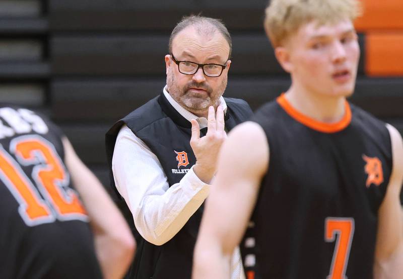 DeKalb head coach head coach Keith Foster talks to his players Tuesday, April 21, 2026 during their match against Naperville North JV at DeKalb High School.