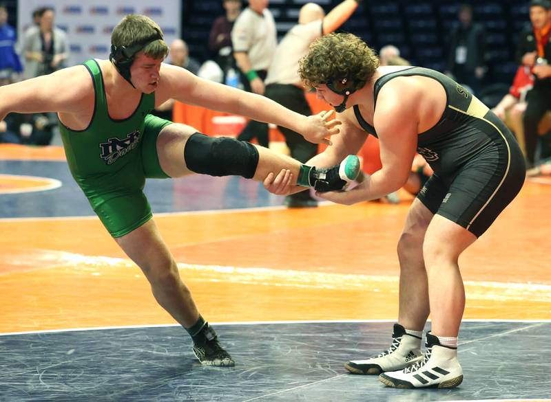 Sycamore’s Lincoln Cooley (right) tries to take down Karl Schmalz during their Class 2A 285 pound match in the IHSA individual state wrestling finals in the State Farm Center at the University of Illinois in Champaign.