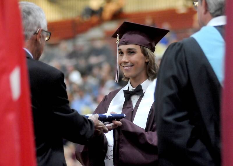 Foreign exchange student Nicolas Henri Butty, of Switzerland, receives an American Flag from his host family Sunday June 5, 2022, during the Marengo Community High School Graduation Ceremony at the school in Marengo.